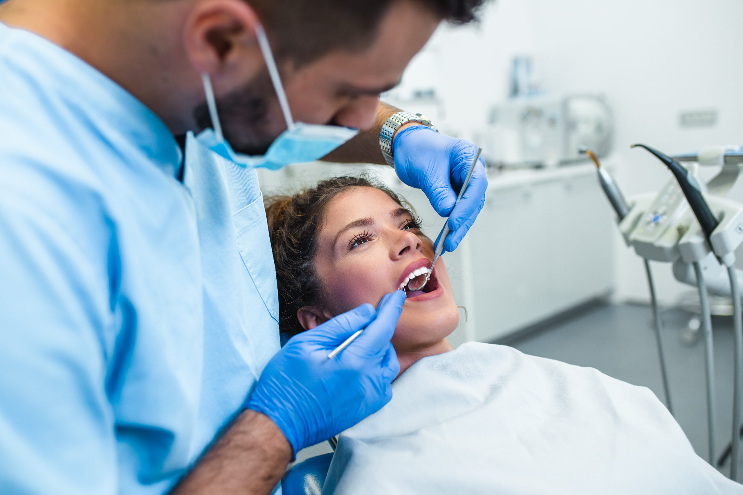 Beautiful young woman having dental treatment at dentist's office.