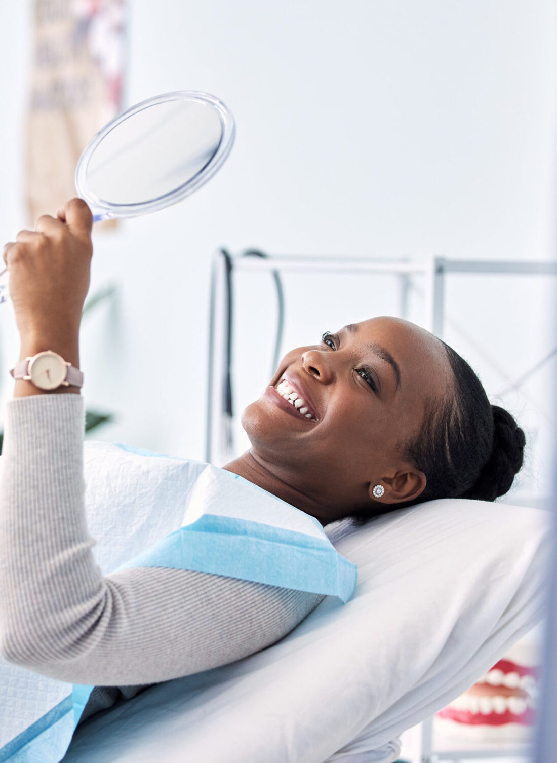 Smile, mirror and black woman at dentist on chair in clinic, tooth treatment and cleaning. Reflection, dental orthodontics and happy person teeth whitening, oral hygiene and healthcare for wellness.