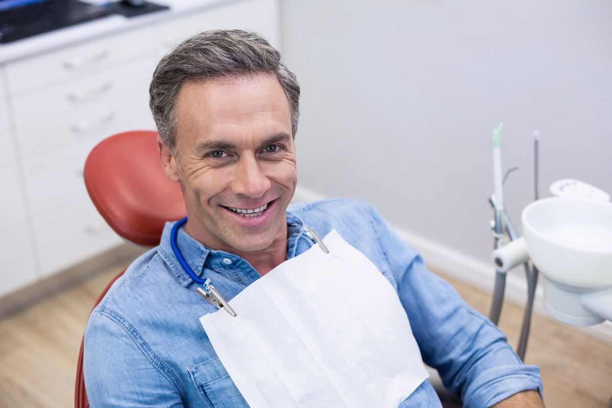 man smiling while facing front