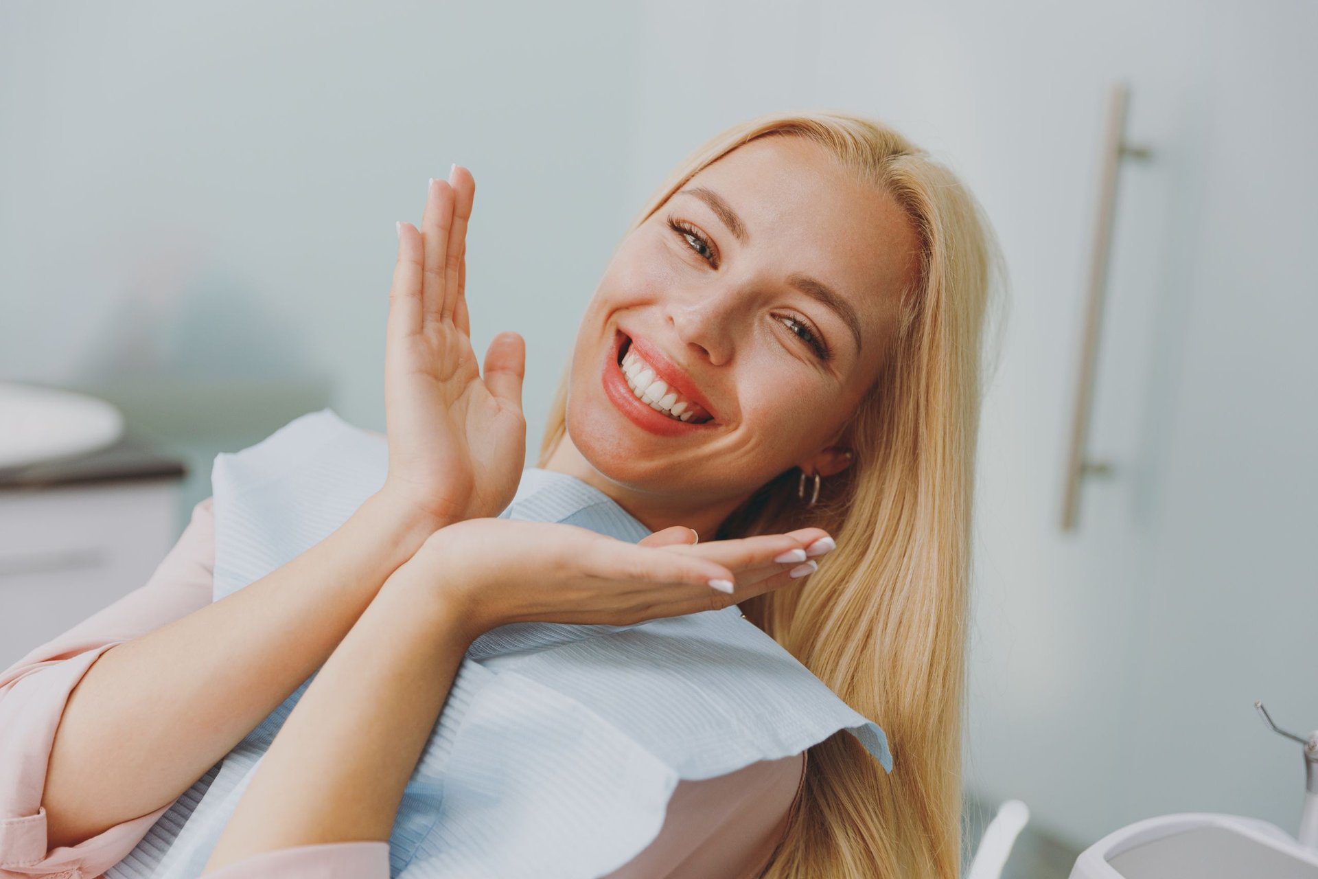 Smiling patient in a dental chair at a cosmetic consultation