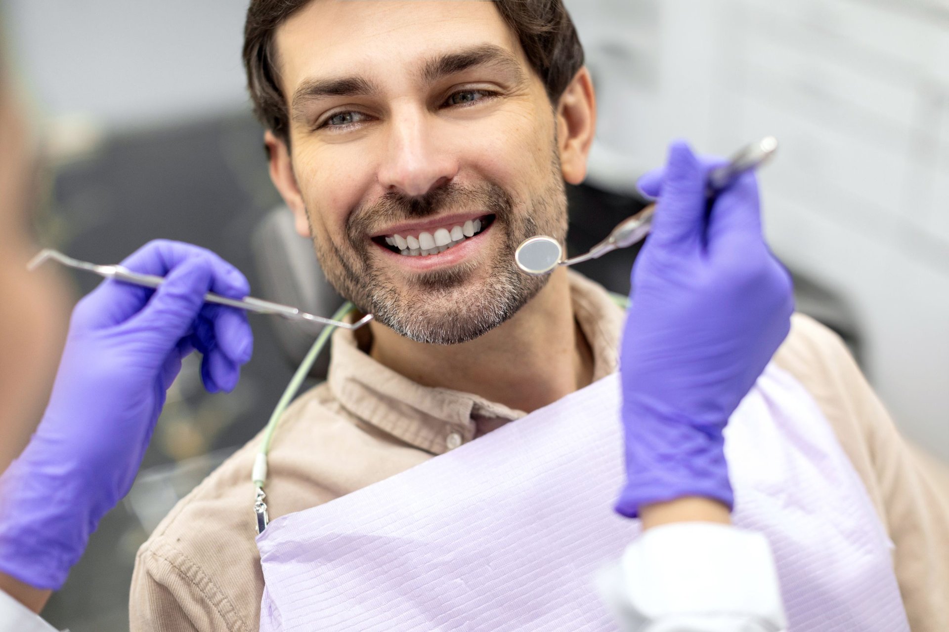 Smiling patient during a cosmetic dentistry exam near Highlands of West Village