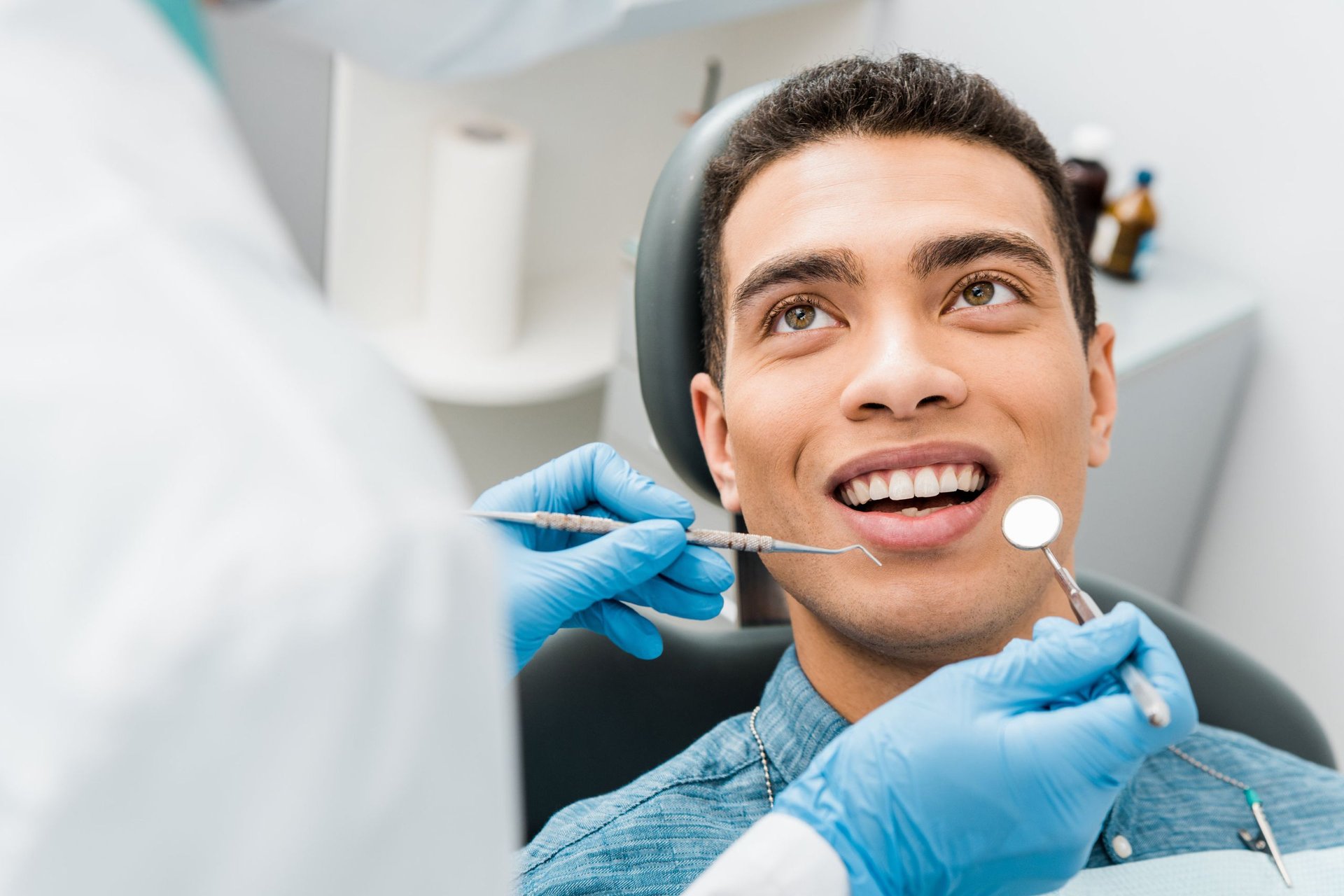 Smiling patient during a dental exam at a cosmetic consultation