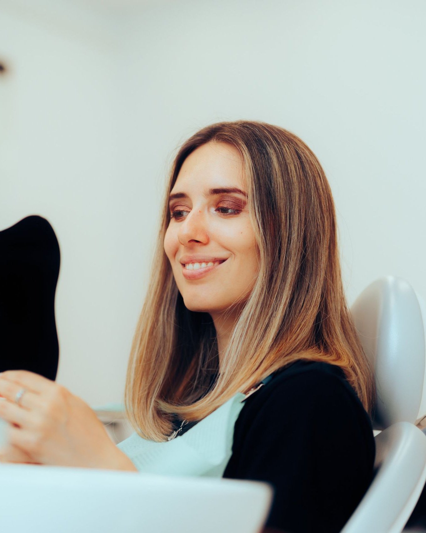 Smiling patient in a bright dental office before teeth whitening