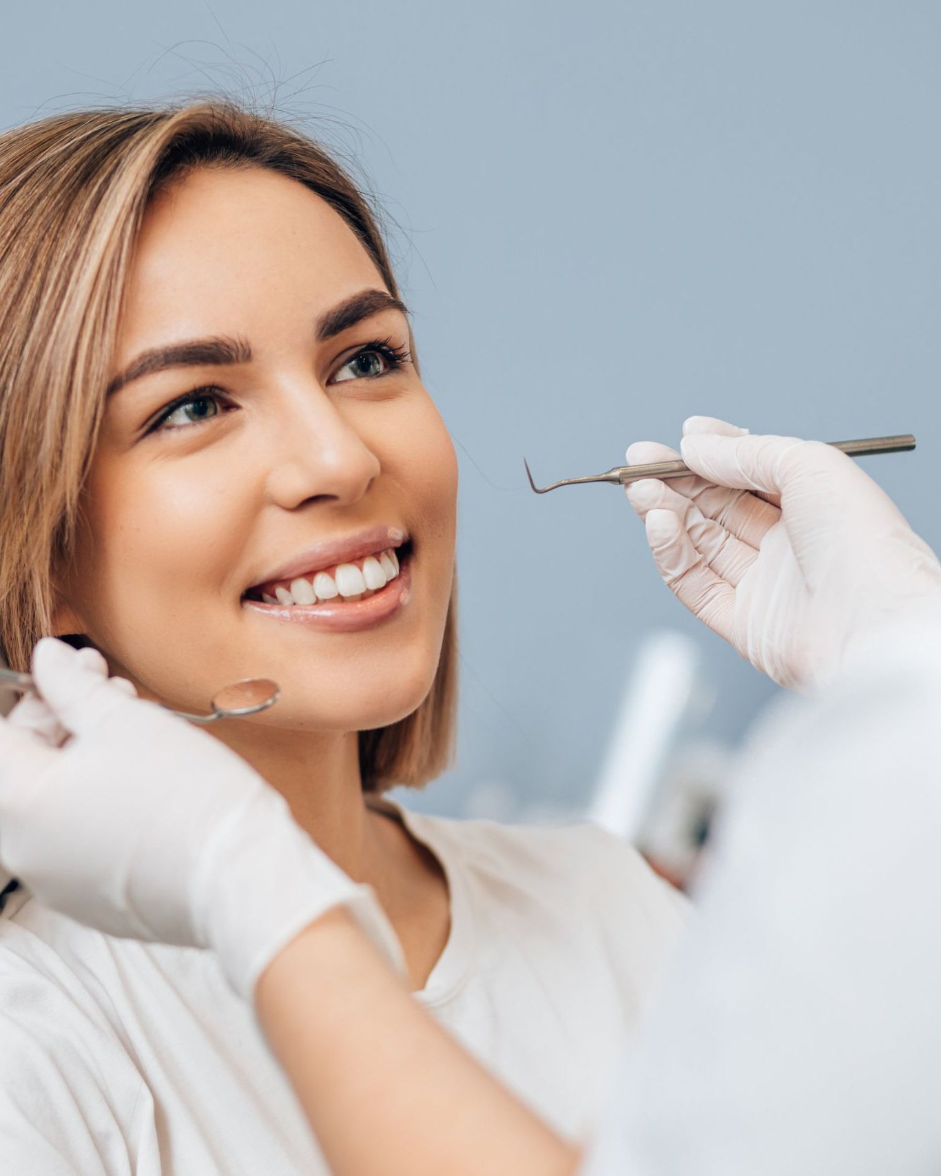 Smiling patient reclining in a dental chair for a whitening visit