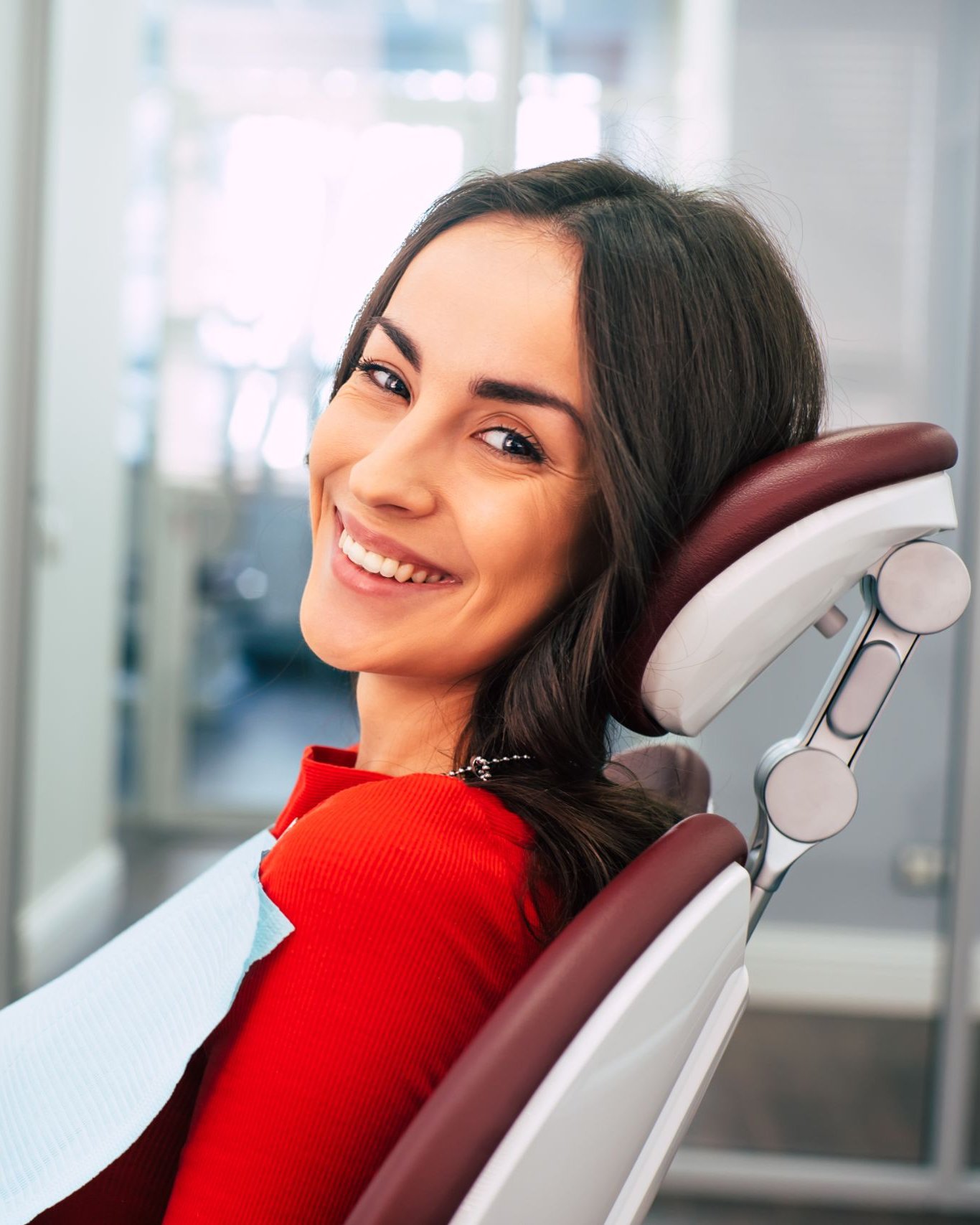 Smiling woman in a dental chair ahead of a teeth whitening visit